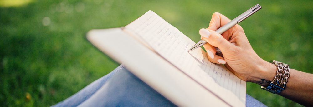 Someone writing in a journal